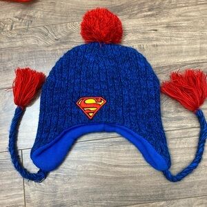 Superman Blue knit winter hat with red tassels and pom pom